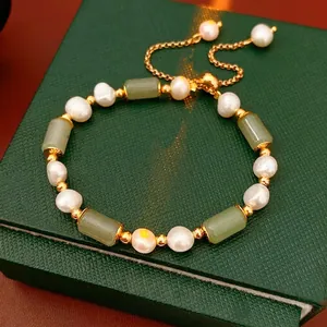 Bamboo style pearl bracelet with green jade beads and gold plating on a gift box