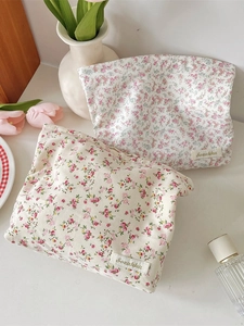 Floral fabric makeup bags with pastel flower patterns and Sozakka label in a still life view