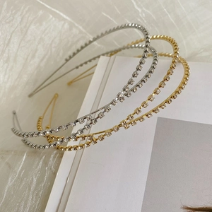 Close-up of elegant gold and silver metal headbands with sparkling rhinestone details