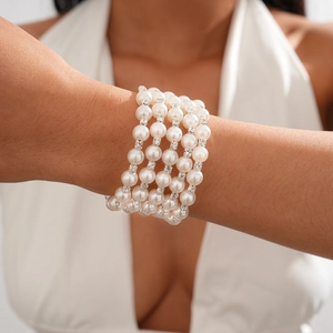 Detail of elegant multilayer faux pearl bracelet with sparkling rhinestone spacers on wrist