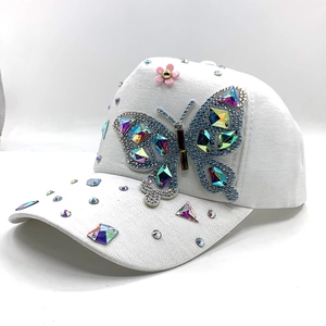 White baseball cap with colorful rhinestone butterfly and pink flower decoration