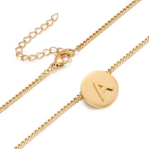 Minimalist gold round pendant necklace featuring embossed letter A with adjustable steel chain