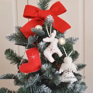 Christmas felt ornaments set with white elk, red socks, and angel on a Christmas tree