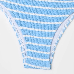 Detailed close-up of blue and white striped seersucker fabric texture on bikini bottom