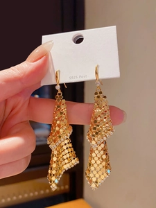 Detail of 18k gold plated fringe earrings with mesh metal tassels and sparkling zircons