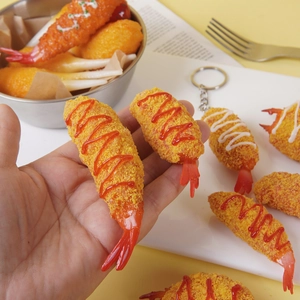 Realistic tempura shrimp keychain with golden texture and red sauce detail in a bowl