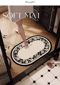 Detail of oval black and white rose bath mat on wooden floor with BETTER LIFE text