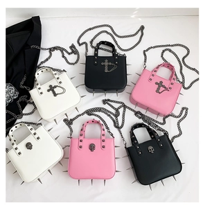 Flat lay of punk gothic crossbody bags with metal studs, skulls and cross pendants