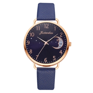Women's rose gold watch with blue moon phase dial and leather strap against white background