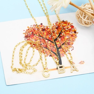 Detail of gold letter pendants A, B, and C with micro-pave cubic zirconia on chain