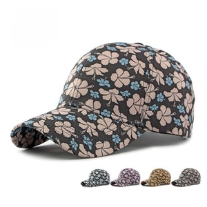 Detail view of various floral baseball caps showing diverse patterns and textures