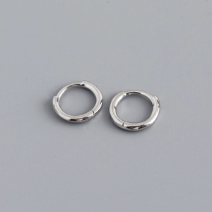 Macro shot of minimalist S925 sterling silver hoop earrings with polished finish