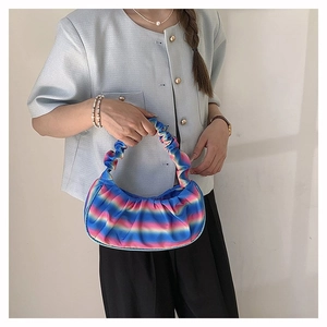 Detail of colorful gradient pleated satin shoulder bag with soft textured handle