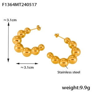 Detail showing 3.1cm stainless steel C-shaped earrings with gold bead-link design