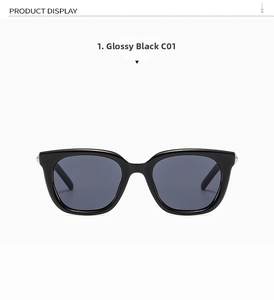 Close-up of black oversized square sunglasses with silver temple accents and dark lenses
