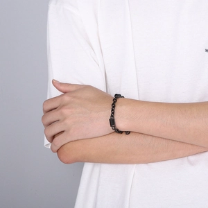 Minimalist black stainless steel chain bracelet with spring links on model's wrist