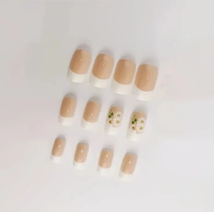 Classic French nude pink press-on nails with white tips and delicate daisy floral designs
