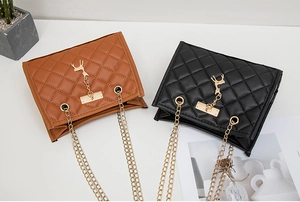 Detailed flat lay of quilted chain crossbody bags in brown and black with gold deer charm