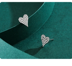 Macro view of S925 sterling silver heart earrings with sparkling pavé cubic zirconia