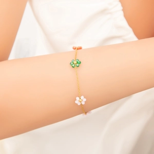 Elegant 18k gold plated titanium steel floral bracelet with green and white petals