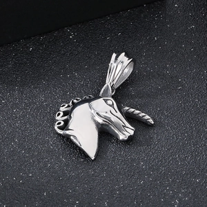 Macro shot of polished silver stainless steel unicorn pendant with intricate mane detail