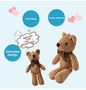 Detailed view of handmade crochet teddy bears with brown bows and soft cotton texture