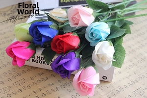 Artistic detail of colorful artificial soap roses with green leaves on music sheet music