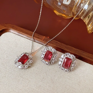 Vue détaillée d'un ensemble collier et boucles d'oreilles aux grandes pierres rouges