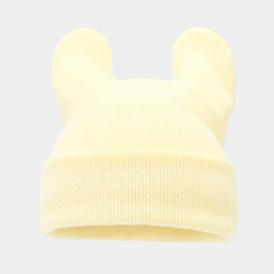 Close-up of light yellow knit hat with cute animal ears showing fine ribbed texture