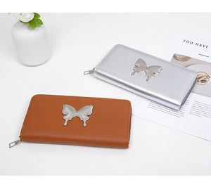 Detail of long butterfly wallets in brown and silver with metallic zipper and butterfly accent