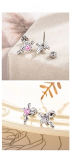 Macro shot of silver cross studs with heart zircon and secure screw back closure