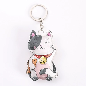 Cute faux leather lucky cat keychain with golden bell and fish charm on white background
