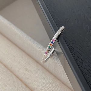 Macro detail of S925 silver beaded ring featuring linear rainbow zircon inlay setting