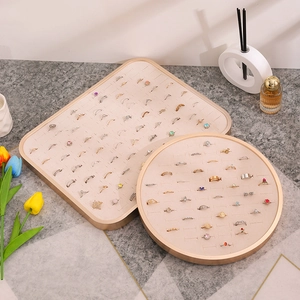 Beige velvet jewelry display trays with champagne gold frames for rings and necklaces