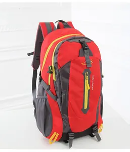 Detail of red and grey outdoor backpack featuring Keep Walking embroidery and yellow zippers