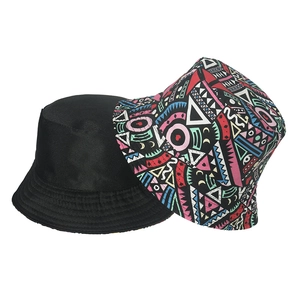 Double-sided reversible bucket hat with black canvas and colorful geometric patterns