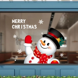 Close-up of festive Merry Christmas window sticker with cartoon snowman and white snowflakes
