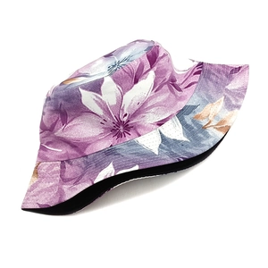 Detail of floral bucket hat with purple flowers, black lining and reversible design