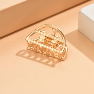 Golden medium metal hair claw clip with elegant hollow D-shape design for women