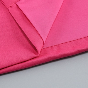 Close-up of pink fabric texture and precise stitching on a slim evening gown