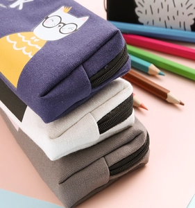 Stack of canvas pencil cases in blue, beige, and grey with cute cartoon cat patterns