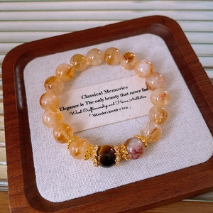 Detail of beaded bracelet with tiger eye and citrine stones in a vintage jewelry box