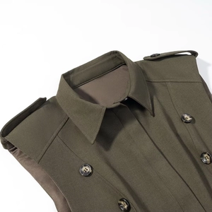Close-up of olive green dress featuring lapel collar, shoulder pads and marble buttons