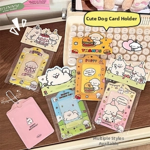 Cute cartoon dog card holders in various colors with metal bead chains on wooden desk
