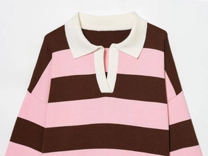 Detail of knit polo shirt featuring bold pink and brown stripes with a white collar