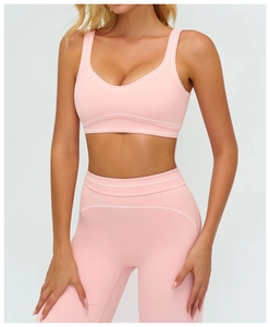 Detail of pink sports bra with U-shape neck and white decorative stitching details