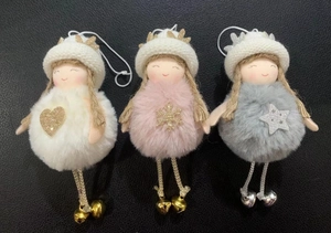 Detailed flat lay of plush Christmas angel ornaments with bells on black background