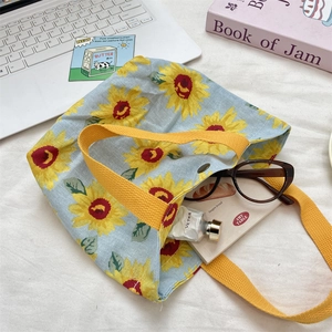 Detail of sunflower canvas tote bag showing interior snap button and storage capacity