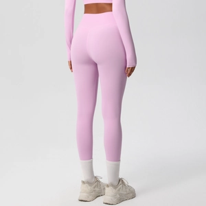Detail view of mauve high-waisted yoga pants with V-shaped stitching for hip contouring