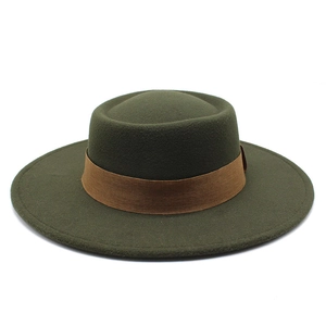 Close-up detail of dark olive wool felt fedora hat featuring a brown decorative band